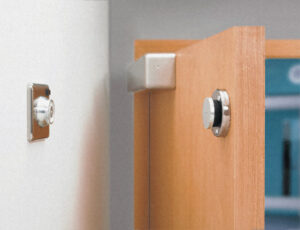 Door with a magnetic holding device has released and the door is closing